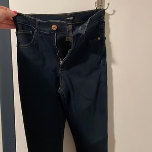 Dark denim express jeans with tan stitching